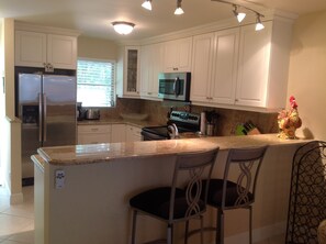 Kitchen with granite countertops and stainless steel appliances.