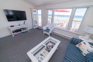 your bright upstairs living room with a killer view and flat-screen TV