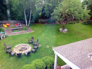 View of the backyard showing fire pit and kayaks