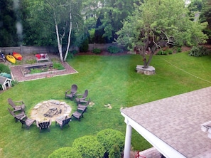 View of the backyard showing fire pit and kayaks