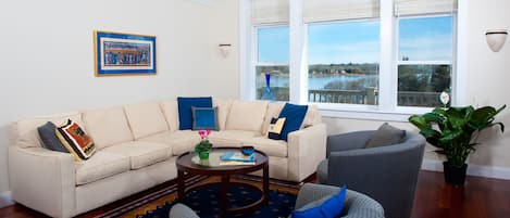 Gather in the living room with views of great salt pond, open to DR and kitchen.