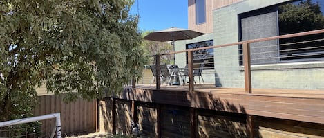 North facing front yard. Decked area with outdoor table and BBQ. Lots of shade.