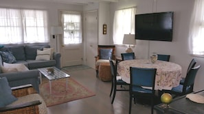 Living room features new hardwood floor, sectional sofa and flat screen HD TV