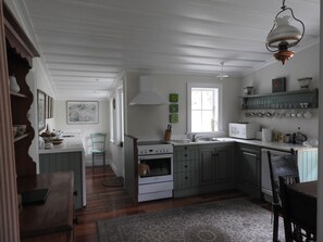 The fully equipped kitchen has French doors onto the veranda for alfresco meals.