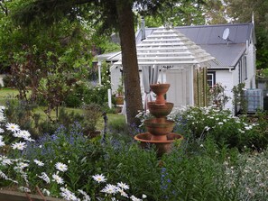 The cottage is just steps away from the  gazebo and rustic hot tub.