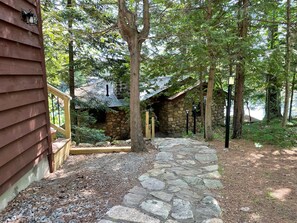 View entering from the back along a newly laid path and stairs, fully lit