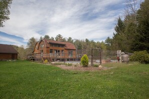 Listing is behind main house and overlooks the in-ground pool.