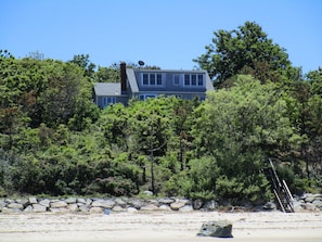 The Woolrych House sits above a private Brewster beach.
