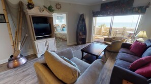 Large family room with access to deck and ocean and beach views. 