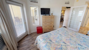 Mater bedroom with TV, deck access and direct ocean views.  