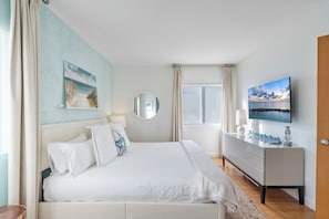 Large primary bedroom  with King size bed, Smart TV and light-blocking curtains