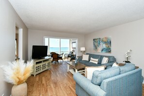 Spacious living room with HDTV, view to Lanai, beach and Gulf of Mexico