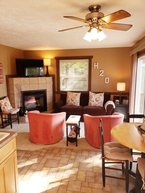 Open concept Living Room, Dining Area and Kitchen with pull out couch.