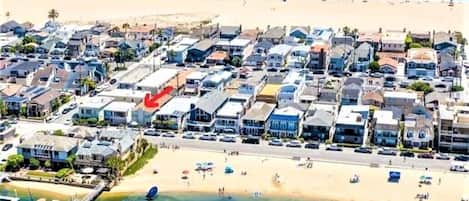 Aerial view of the property and location. Across from sandy bay front beach