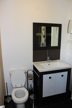 Bathroom with toilet, sink and shower