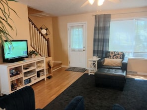 Living room with large
tv and stairs to the bedroom level