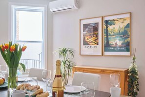 Nice decor in dining area, view on the terrace, AC unit to cool the back of the apartment