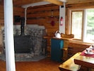 Woodstove and dining area.
