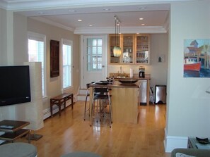 Living room to kitchen- door leading to deck on left