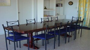 The red-gum table seats 10 guests.