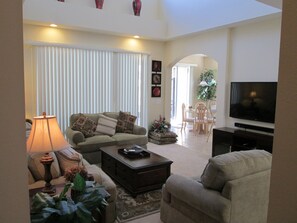 Living room overlooking the breakfast area,with the entrance to pool.