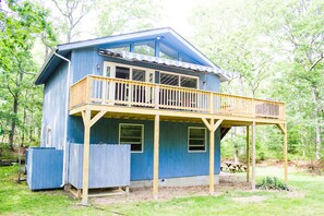 The outdoor shower tucked under the deck.