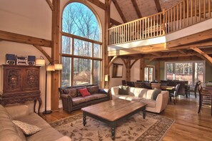 Large Living Room with tons of natural light & wood burning fireplace.