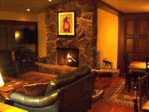 Living Room With Vaunted Ceiling, Wood Fireplace, and soft Leather Seats