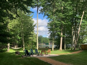 Firepit area with plenty of seating and Hammock