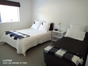 Bedroom 1 a queen and a single bed