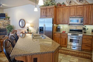 Granite counters, slate tile, and beautiful cabinetry