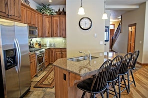 Additional view of the kitchen and island with bar seating