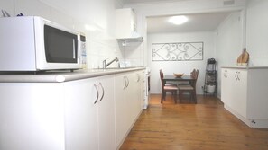 Fully equipped kitchen with oven, cook top and microwave