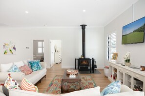 Main lounge room with fireplace, lower floor.