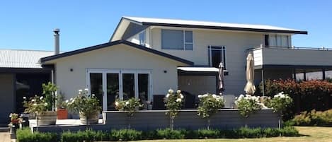 Frontage Rata Street with large deck and outdoor table and chairs 