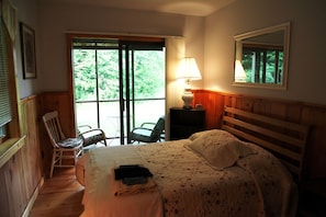 Cozy bedroom with double bed and screened-in porch