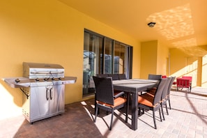 Patio table with 8 chairs and BBQ gas grill.