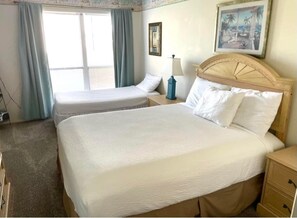 Condo BR with queen size bed and twin bed and HDTV.