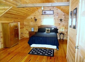 Upstairs loft area bedroom with queen size bed and private bathroom