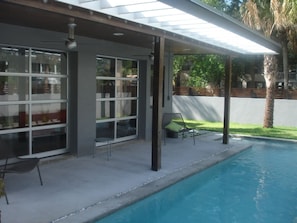 Sunroom with double garage doors on to pool