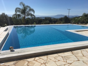 The pool at Villa Livadia in the sun during the day.