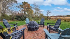 Patio with Adirondack chairs and firepit