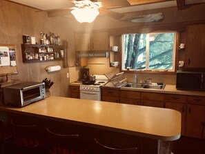 Fully outfitted kitchen; electric stove, convection oven/toaster, coffee maker.
