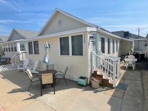 Outdoor patio and dining area and Adirondack chairs in the sand! 