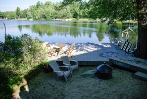 Sand/beach area next to dock with firepit.  Walk-in access to lake.