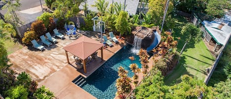 Cottage and pool area with surrounding tropical foliage 