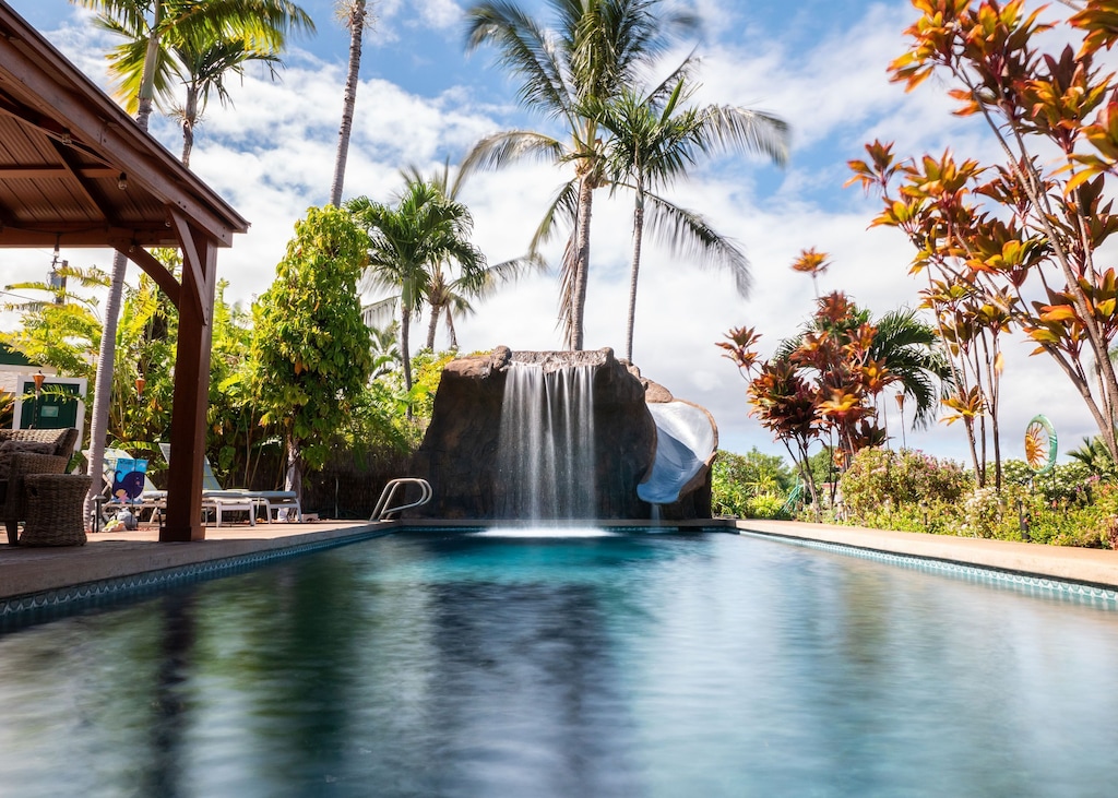 The pool with waterfall and slide in a tropical setting makes this one of the best vacation rentals on the south side of Maui