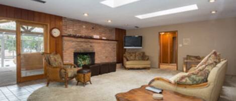 Living room just off of kitchen with large sky lights.