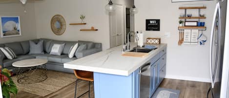 Kitchen counter with bar area with 4 bar stools.  