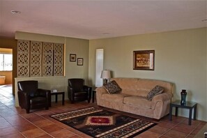 Your living room with flat screen TV and pull out sofa for extra sleeping